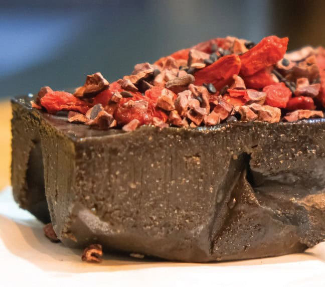 close up of black tahini lions mane fudge with goji berries