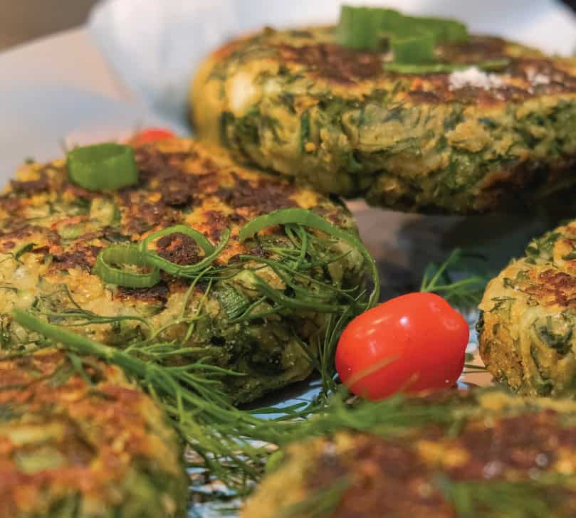 zucchini fritters on pan with dill