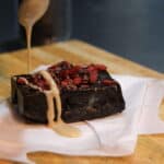 black tahini fudge with tahini being poured overtop
