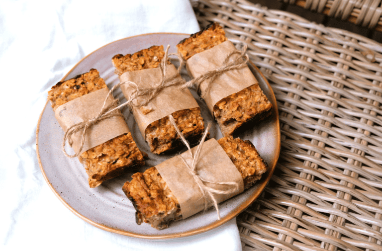 four oatmeal bars on plate wrapped in brown paper