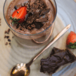 chocolate mousse with gold spoon, choc flakes and strawberry