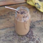 choc peanut butter smoothie in a jar with a straw
