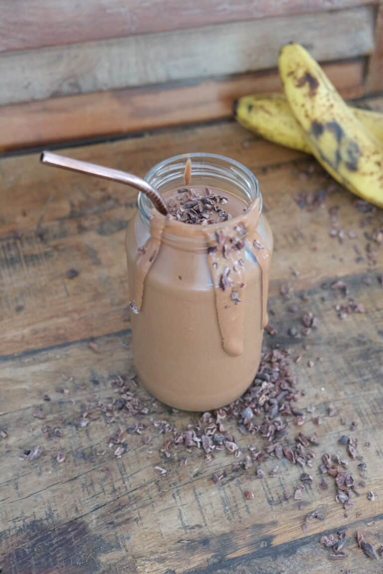 choc peanut butter smoothie in a jar with a straw