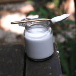 coconut yoghurt in a jar with a spoon on top