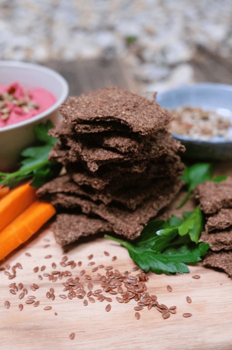 crackers in a stack with veggies and dip