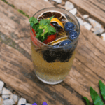 iced tea with orange, mint, blueberries and strawberries