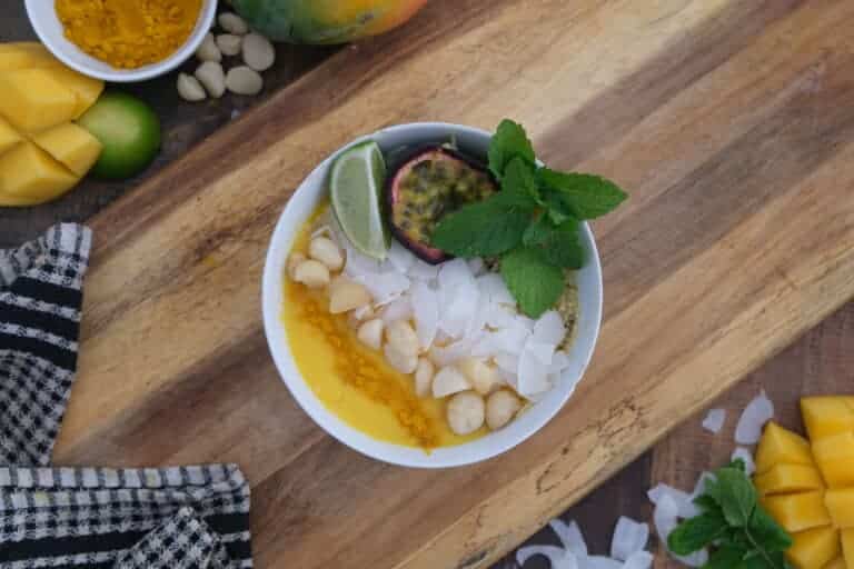 mango smoothie bowl with coconut, macadamias and passionfruit