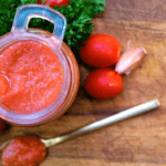 natural tomato sauce in glass gar and spoon