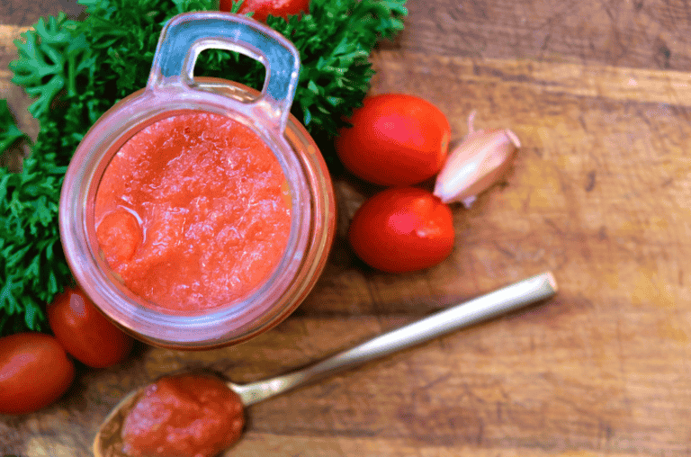 natural tomato sauce in glass gar and spoon