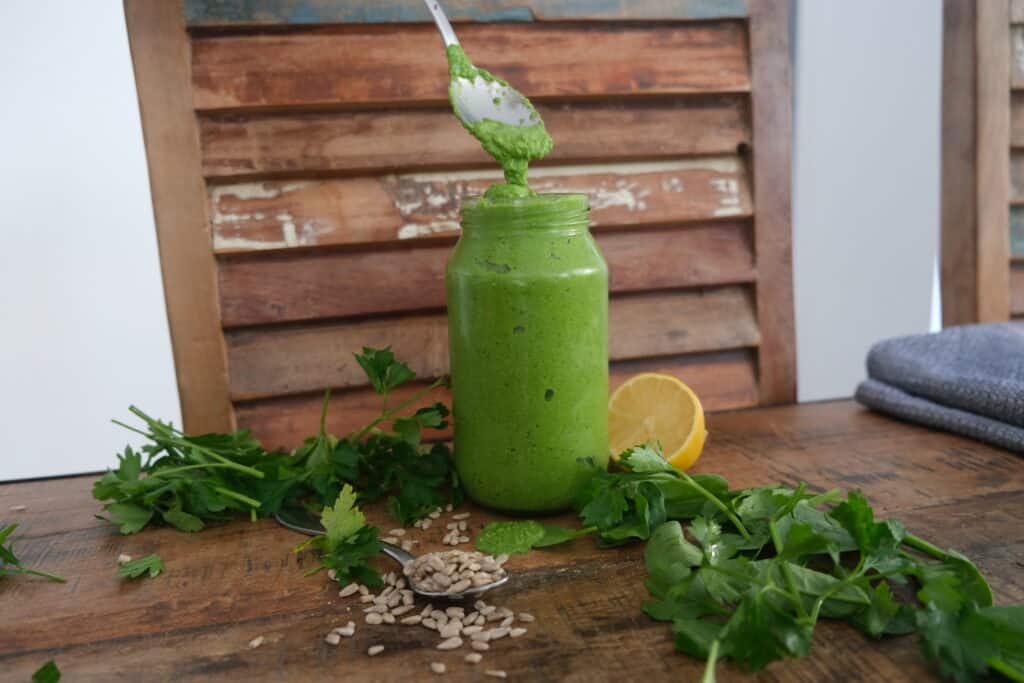 sunflower seed pesto  being poured into jar