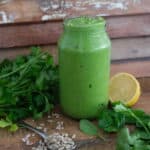 sunflower seed pesto with lemon, lime and parsley surrounding the jar