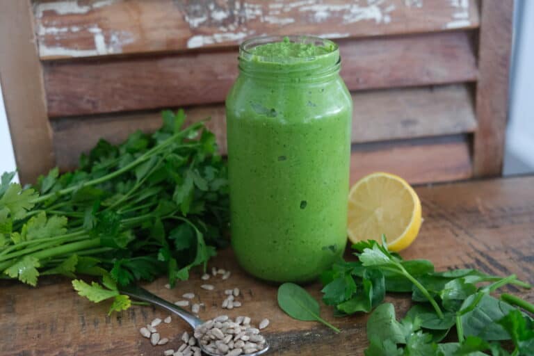 sunflower seed pesto with lemon, lime and parsley surrounding the jar