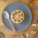 raw carrot cake from above with spoon and nuts sprinkled around