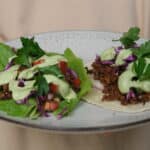 walnut mince tacos - on in lettuce cup and another in tortilla on a plate