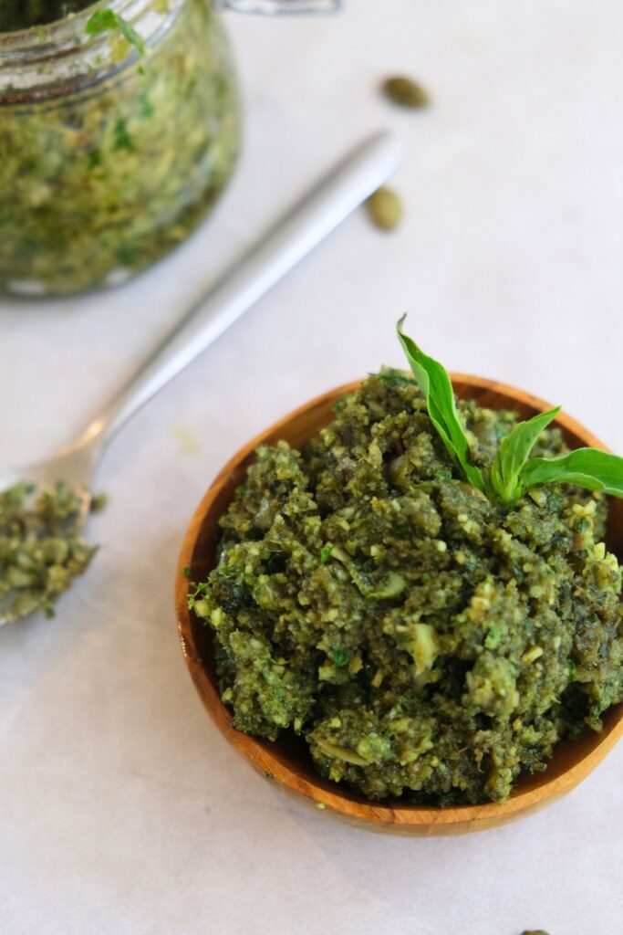 pesto in wooden bowl with spoon 