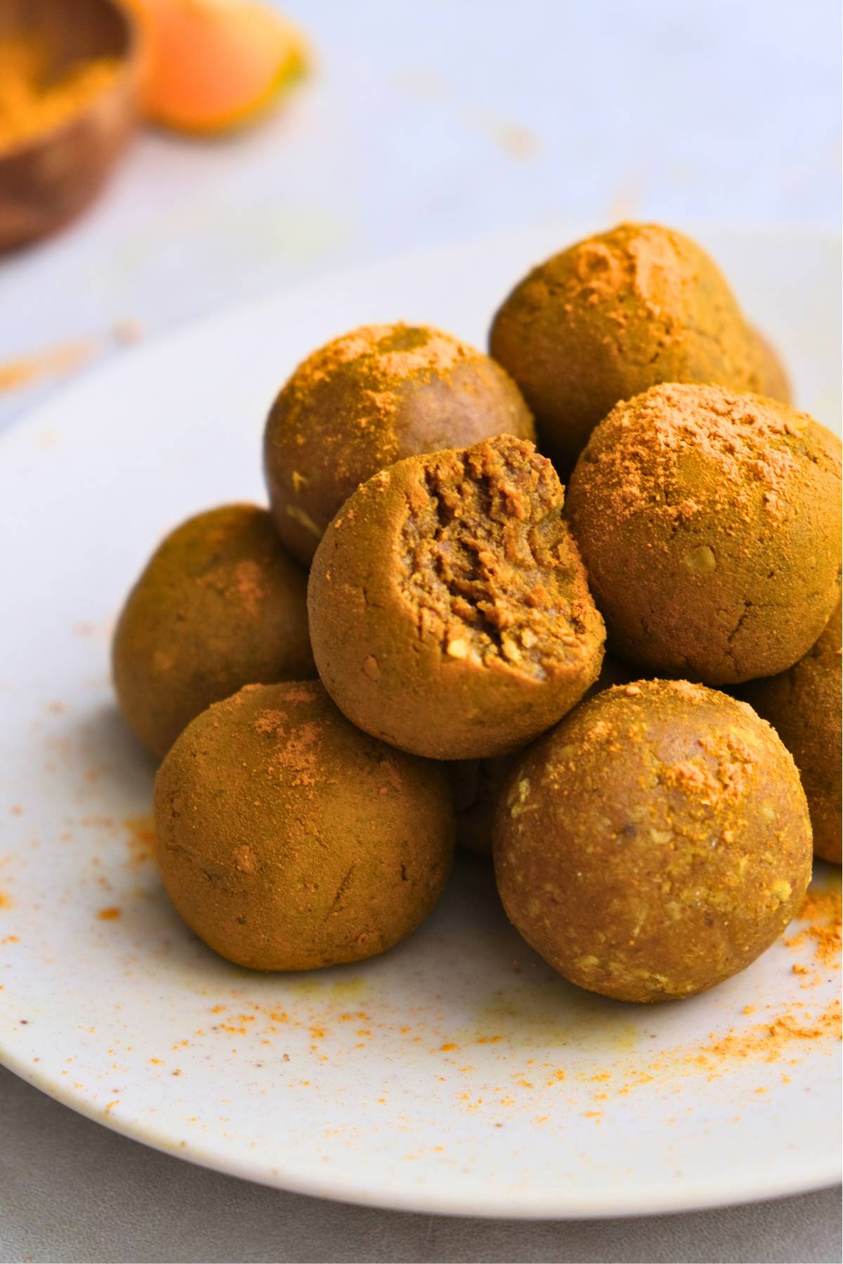 turmeric bliss balls in pile with one bite taken out