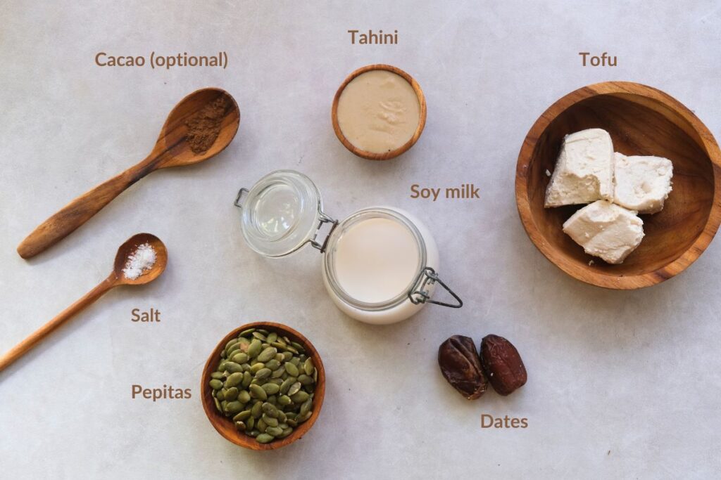 Ingredients picture showing cacao, tahini, salt, pepitas, soy milk, dates and tofu. 